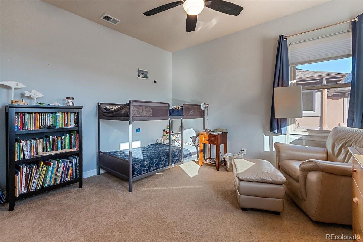 3436 Willow Street Denver, CO 80238 - Photo 21 of 37 a bedroom with furniture and a book shelf