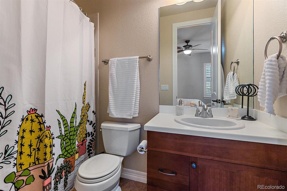 3436 Willow Street Denver, CO 80238 - Photo 22 of 37 a bathroom with a toilet sink and mirror
