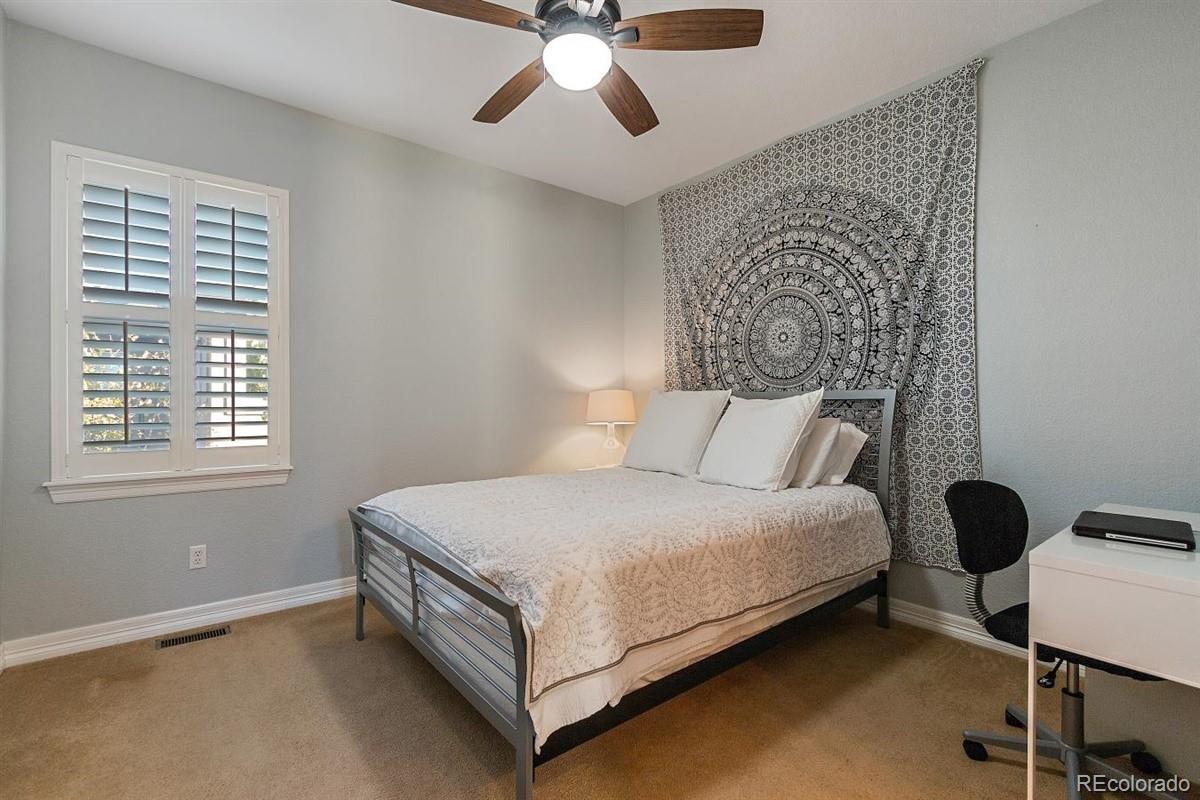 3436 Willow Street Denver, CO 80238 - Photo 23 of 37 a bed room with a bed and a chandelier
