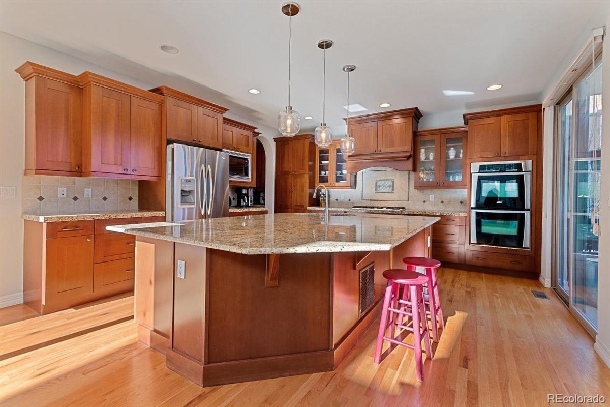 3436 Willow Street Denver, CO 80238 - Photo 3 of 37 a kitchen with stainless steel appliances granite countertop a sink a stove and a refrigerator