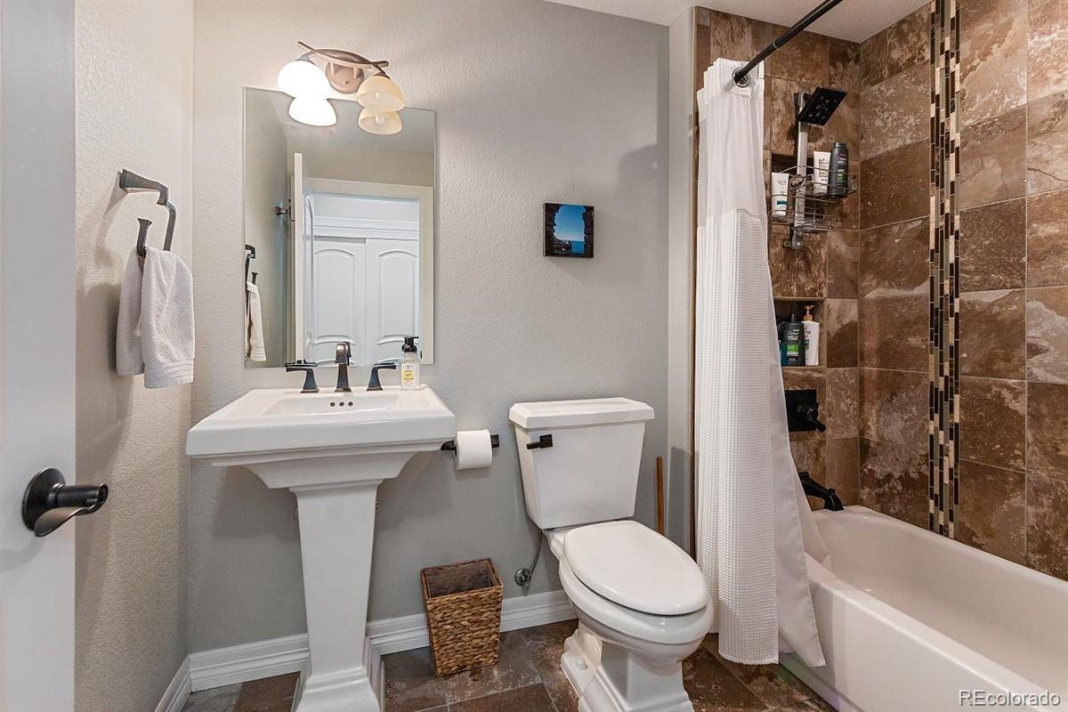 3436 Willow Street Denver, CO 80238 - Photo 31 of 37 a bathroom with a sink toilet and shower