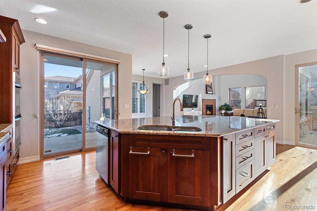3436 Willow Street Denver, CO 80238 - Photo 5 of 37 a kitchen with kitchen island granite countertop a sink and a refrigerator