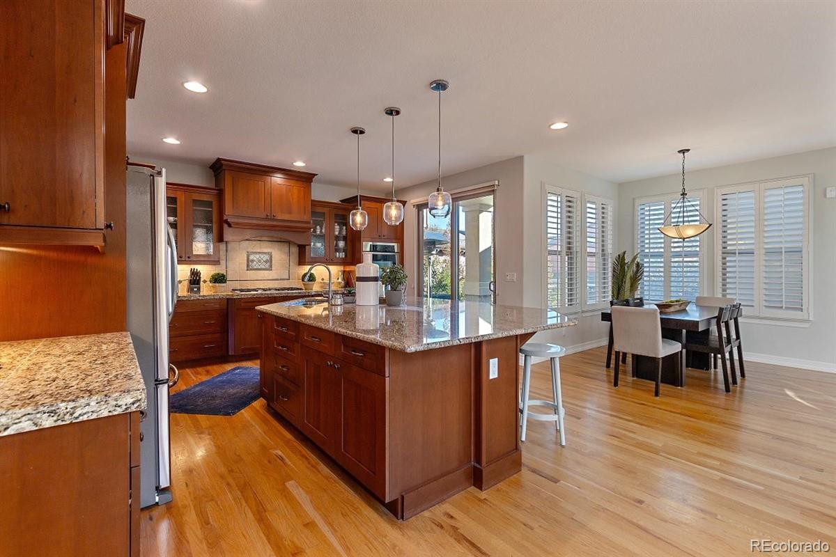 3436 Willow Street Denver, CO 80238 - Photo 7 of 37 a kitchen with stainless steel appliances granite countertop a stove and a wooden floors