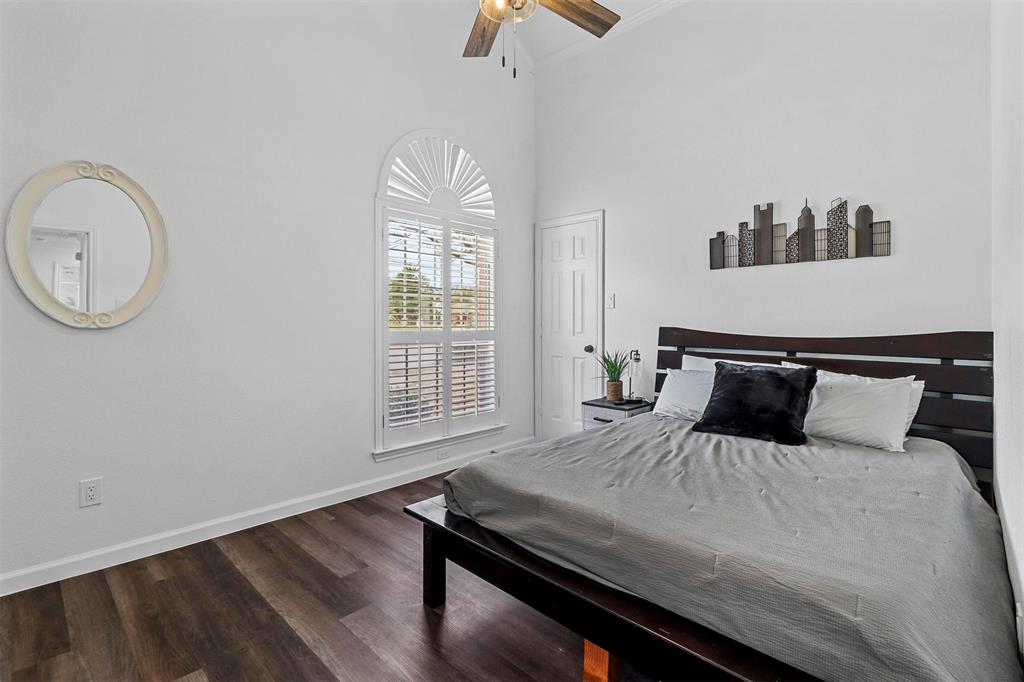 17708 Hillcrest Road Dallas, TX 75252 - Photo 14 of 27 a bedroom with a bed and a chandelier