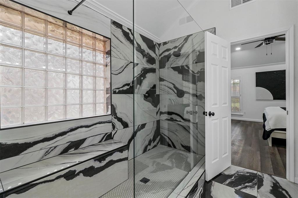 17708 Hillcrest Road Dallas, TX 75252 - Photo 16 of 27 a bathroom with a granite countertop sink a mirror and shower