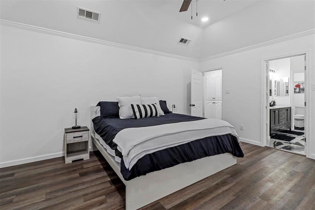 17708 Hillcrest Road Dallas, TX 75252 - Photo 18 of 27 a bedroom with a bed and wooden floor