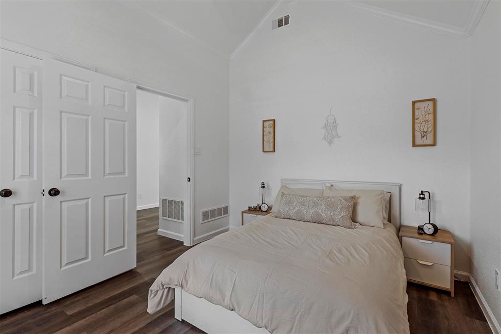 17708 Hillcrest Road Dallas, TX 75252 - Photo 21 of 27 a bedroom with a bed and wooden floor