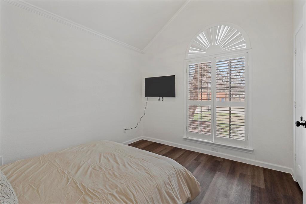 17708 Hillcrest Road Dallas, TX 75252 - Photo 22 of 27 a bedroom with a bed and a window