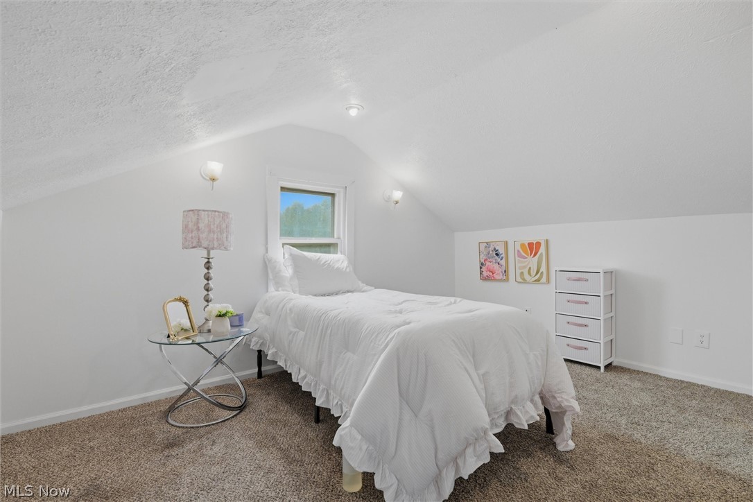 5860 Kirk Road Canfield, OH 44406 - Photo 16 of 17 Carpeted room featuring a single window, sloped ceilings, and wall sconces