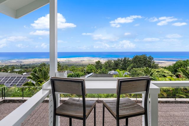 a view of a chairs and table in the balcony