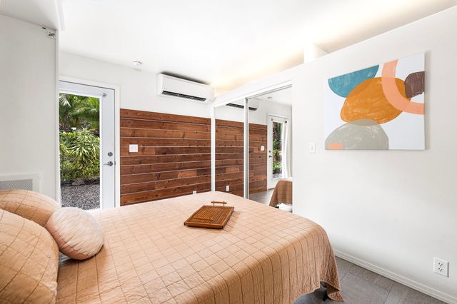 a bedroom with a bed and a large window