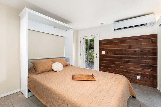 a bedroom with a bed and dresser