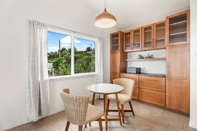 a dining room with furniture a chandelier and window
