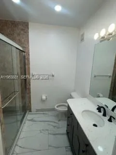 a bathroom with a sink toilet and shower