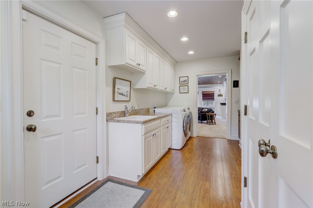 102 Wolcott Road Akron, OH 44313 - Photo 20 of 48 Laundry room with light colored carpet, washer and dryer, sink, and cabinets