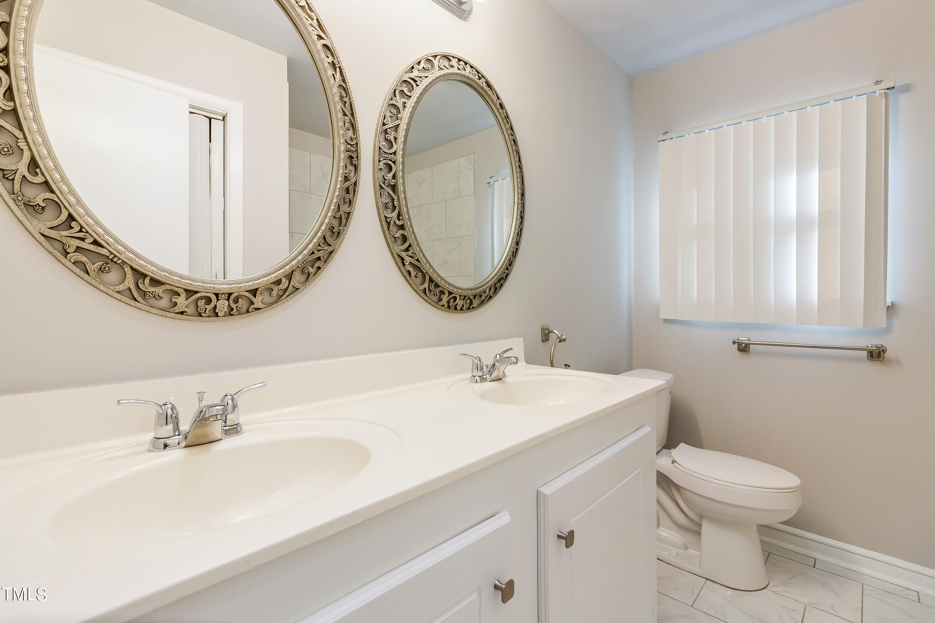 1617 Cameron Drive Wake Forest, NC 27587 - Photo 11 of 21 a bathroom with a toilet a sink and a mirror