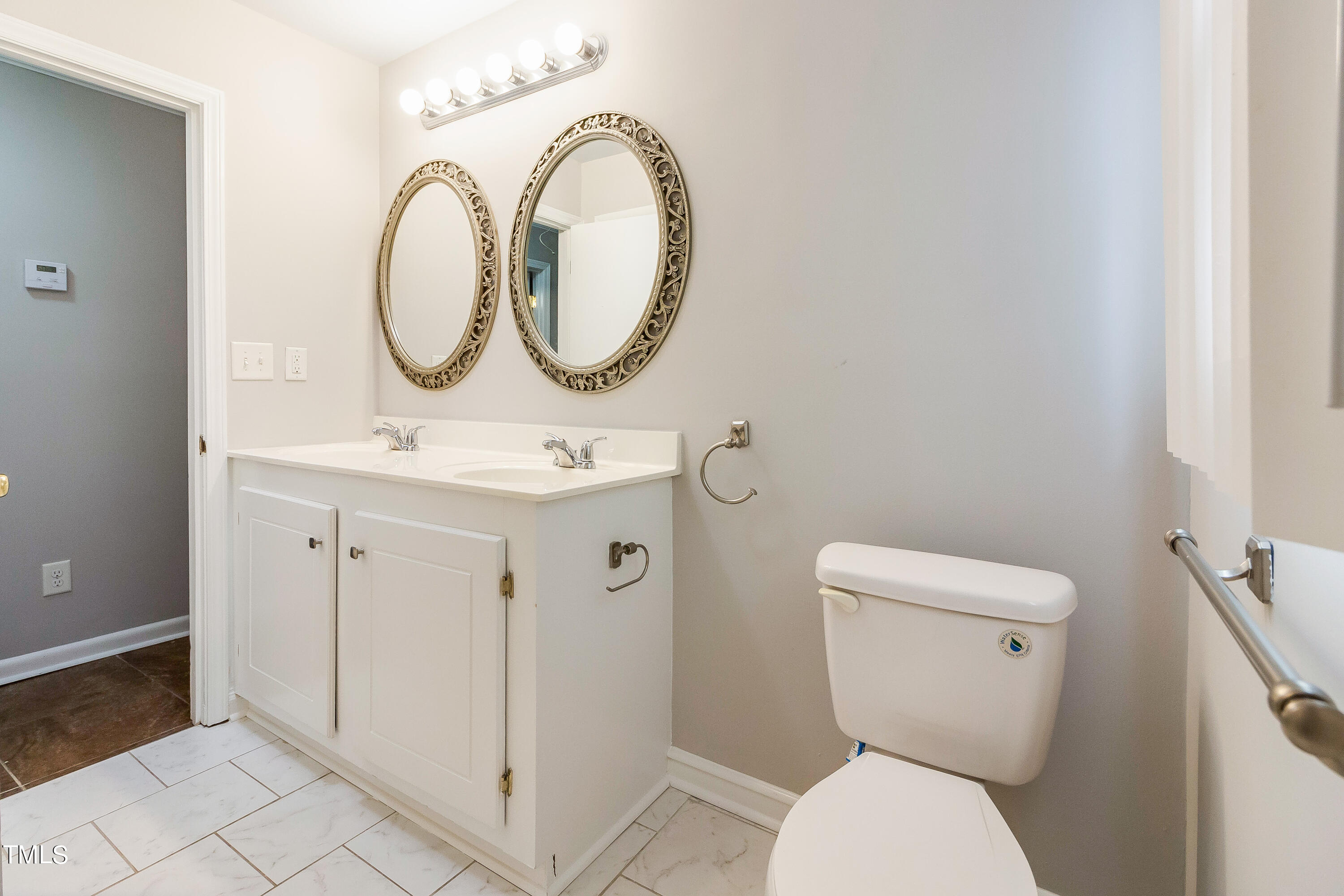 1617 Cameron Drive Wake Forest, NC 27587 - Photo 12 of 21 a bathroom with a toilet a sink and a mirror