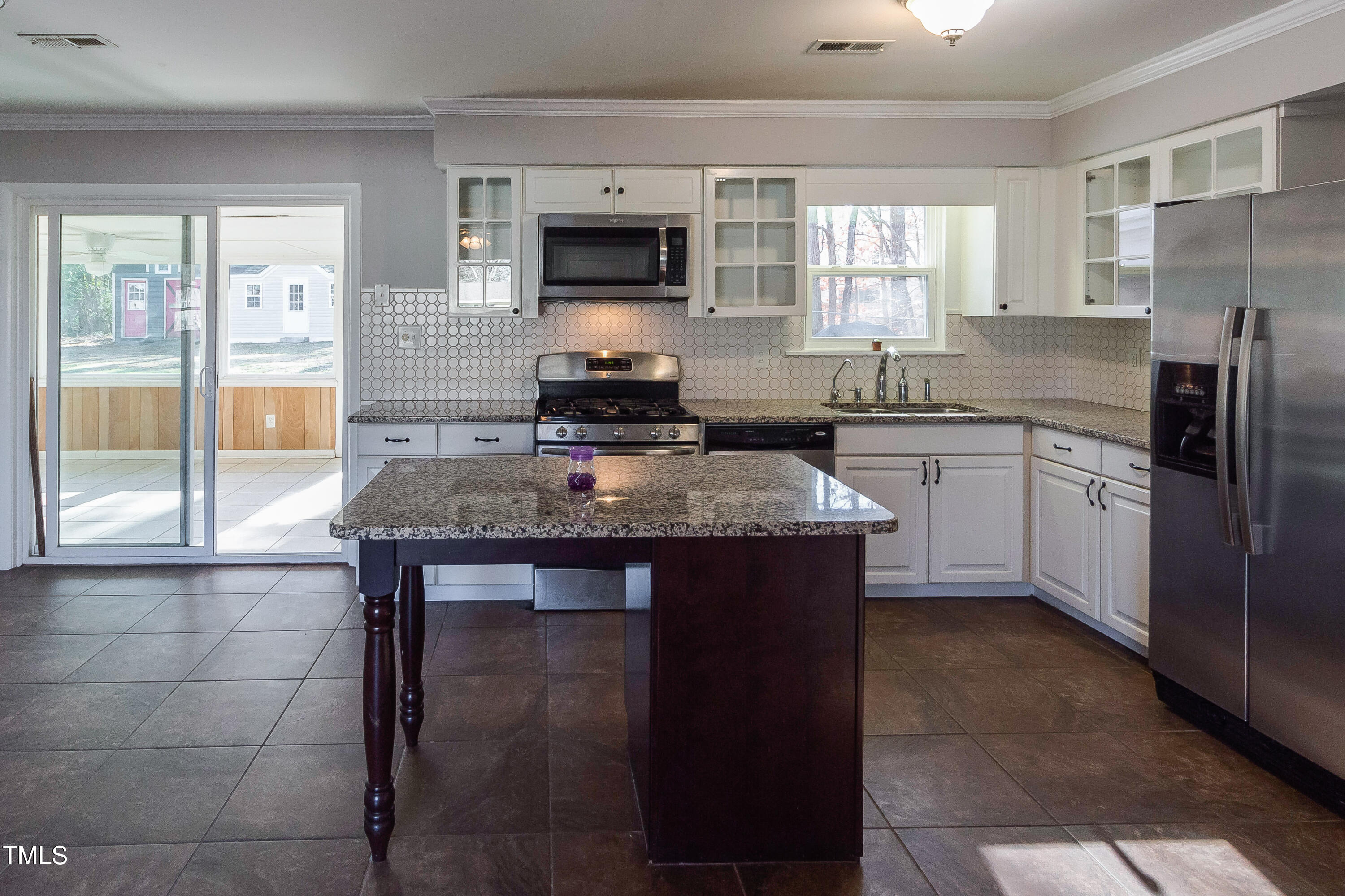 1617 Cameron Drive Wake Forest, NC 27587 - Photo 4 of 21 a kitchen with kitchen island granite countertop a stove top oven a sink dishwasher a dining table and chairs with wooden floor