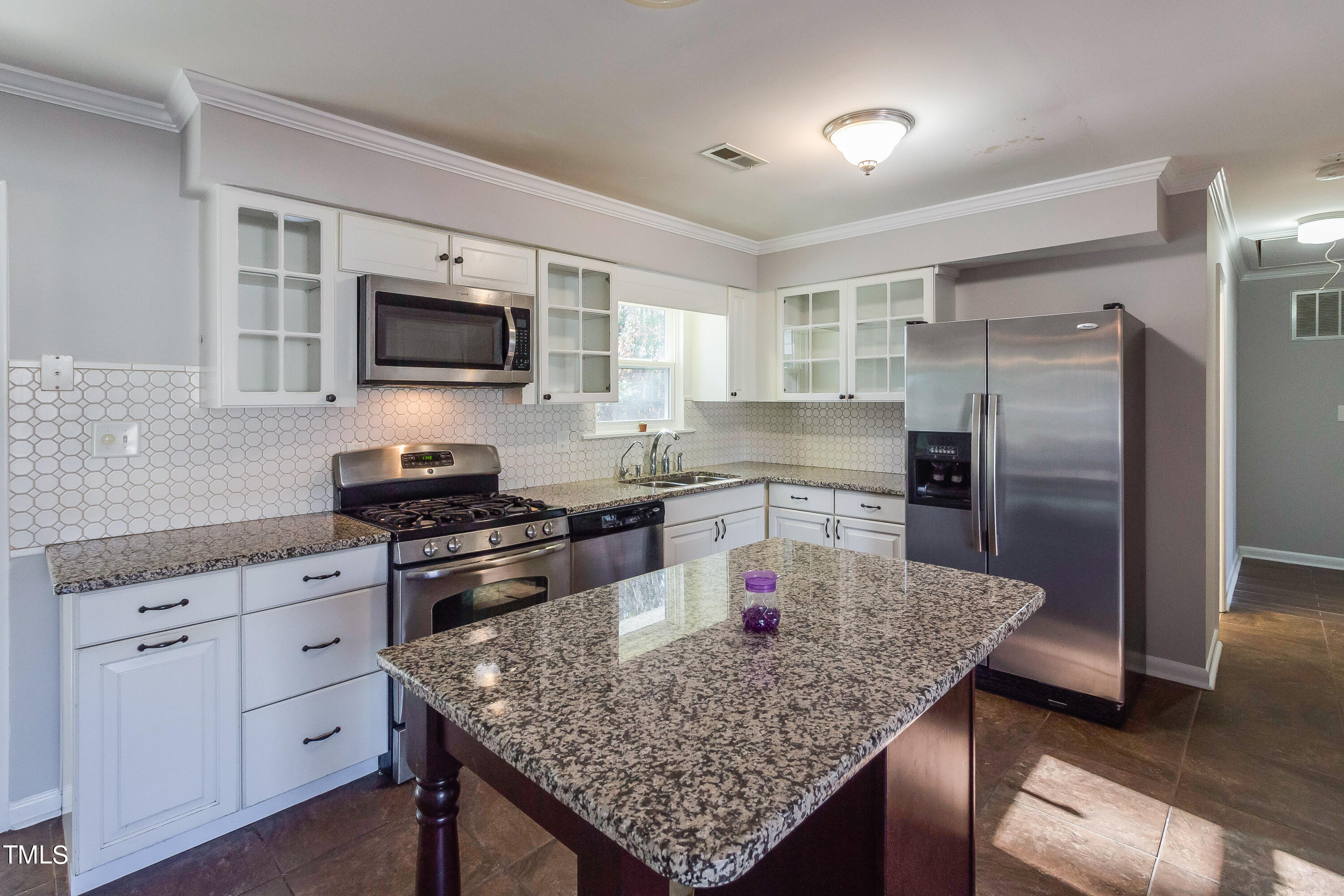 1617 Cameron Drive Wake Forest, NC 27587 - Photo 5 of 21 a kitchen with kitchen island a counter space a sink appliances and cabinets
