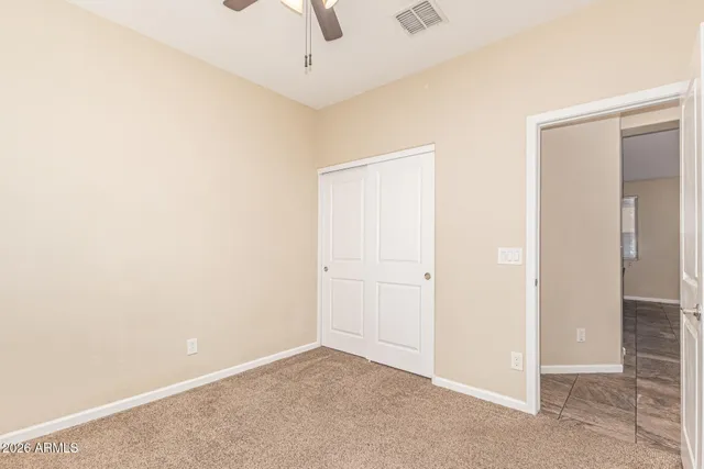 an empty room with a ceiling fan