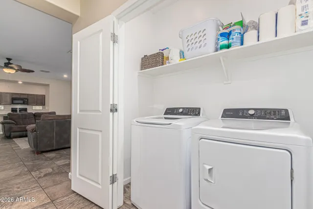 a view of washer and dryer with kitchen in the background