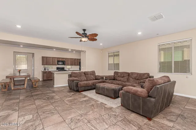 a living room with furniture and kitchen view