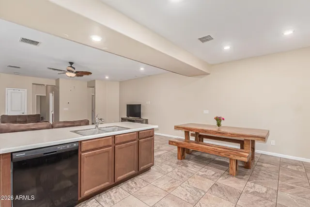 a spacious bathroom with a sink a toilet and a mirror