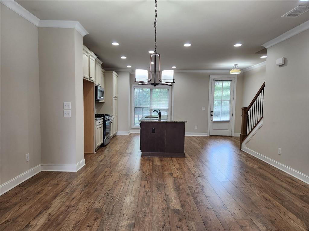 1323 Faircrest Way Suwanee, GA 30024 - Photo 8 of 16 a living room with furniture and a wooden floor