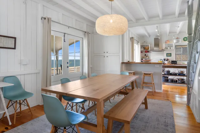 a dining room with furniture and wooden floor