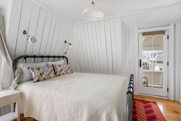 a bedroom with bed and a window