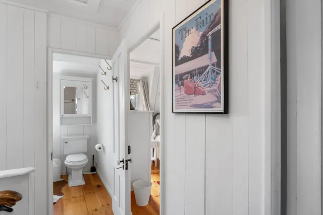 a view of a bathroom with a painting on the wall