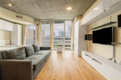 a living room with furniture and a flat screen tv
