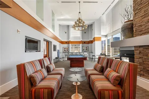 a living room with furniture and a chandelier