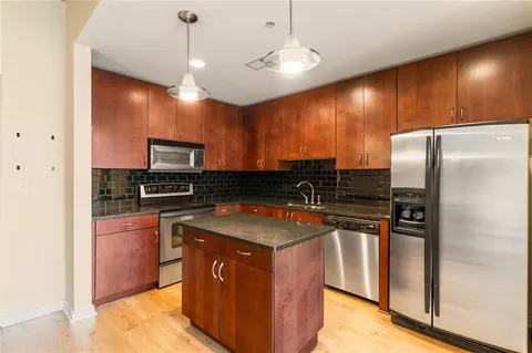 a kitchen with stainless steel appliances a sink stove and cabinets