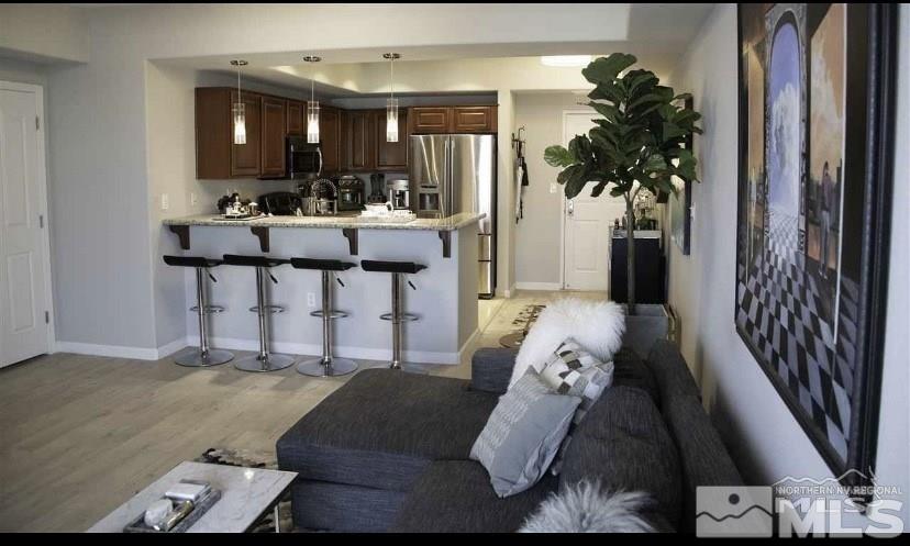 200 West 2nd Street, Unit 1502 Reno, NV 89501 - Photo 11 of 29 a living room with furniture and a potted plant