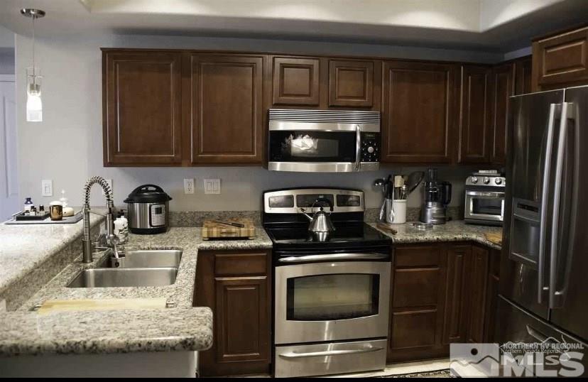 200 West 2nd Street, Unit 1502 Reno, NV 89501 - Photo 12 of 29 a kitchen with granite countertop a sink stove and microwave