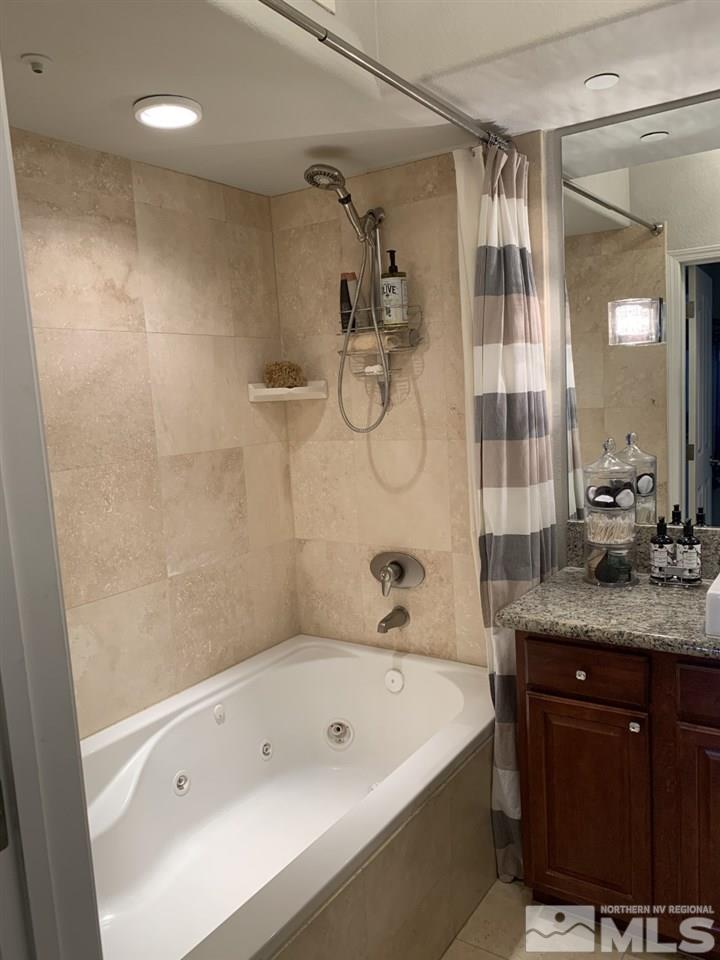 200 West 2nd Street, Unit 1502 Reno, NV 89501 - Photo 22 of 29 a bathroom with a granite countertop sink a toilet and shower
