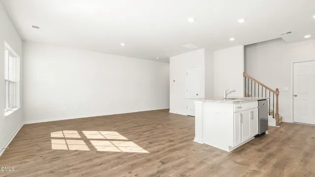 a view of kitchen with granite countertop cabinets and sink
