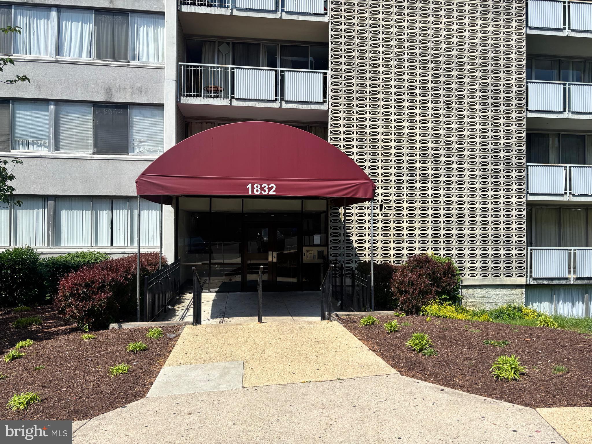1832 Metzerott Road, Unit 403 Hyattsville, MD 20783 - Photo 1 of 15 a front view of a building with garden