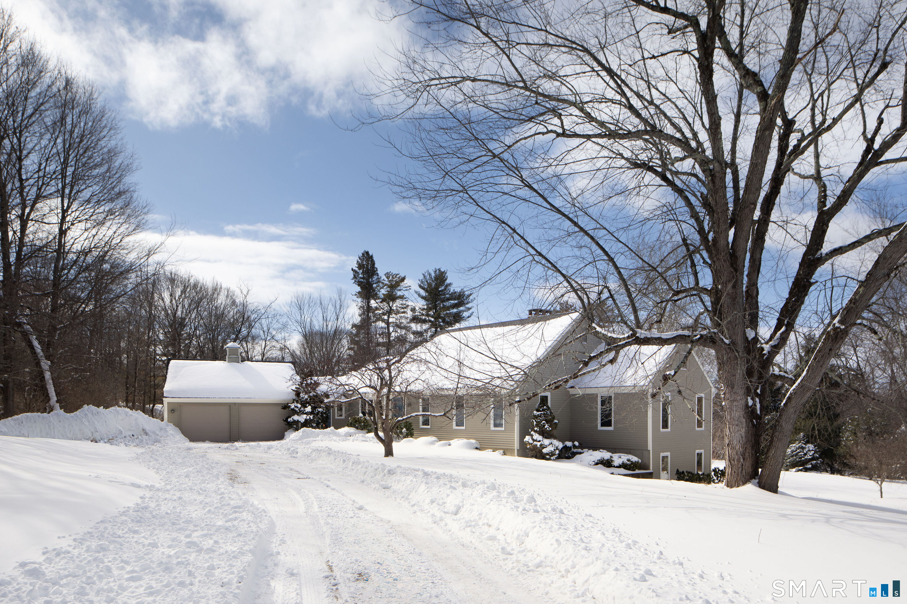 a view of a house with a snow in front of yard