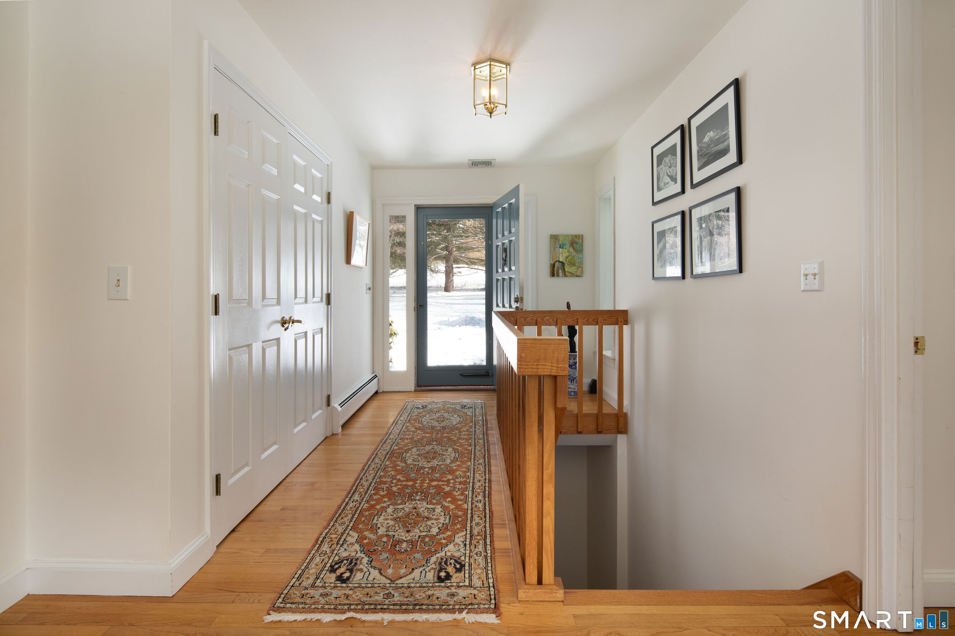 59 Cornwall Bridge Road Sharon, CT 06069 - Photo 2 of 26 a view of a hallway with wooden floor and a living room