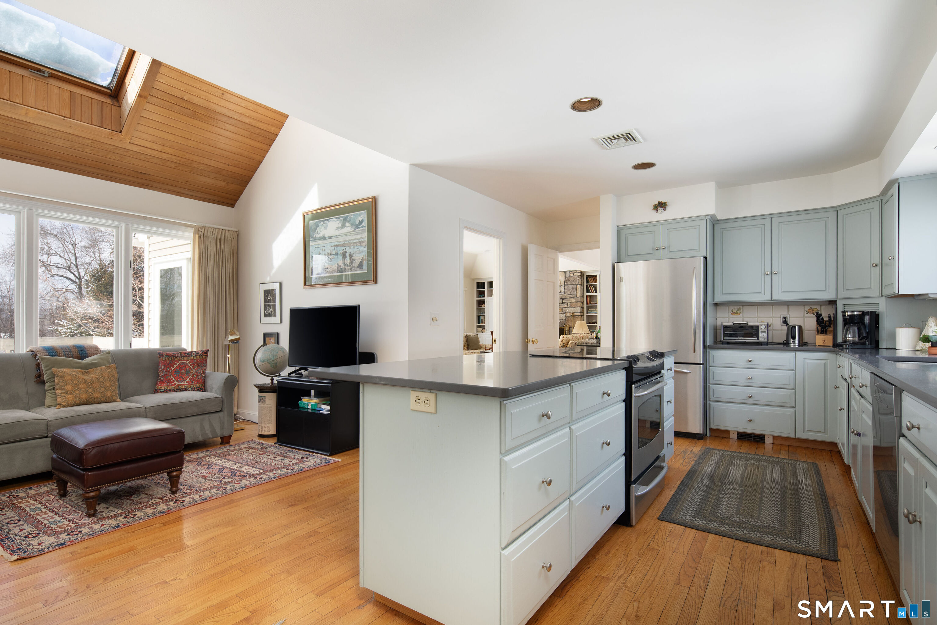 59 Cornwall Bridge Road Sharon, CT 06069 - Photo 7 of 26 a large kitchen with stainless steel appliances granite countertop a couch and a view of living room