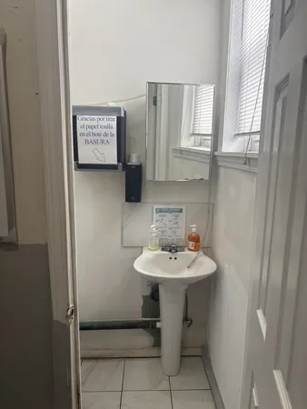 a bathroom with a sink a mirror and a toilet