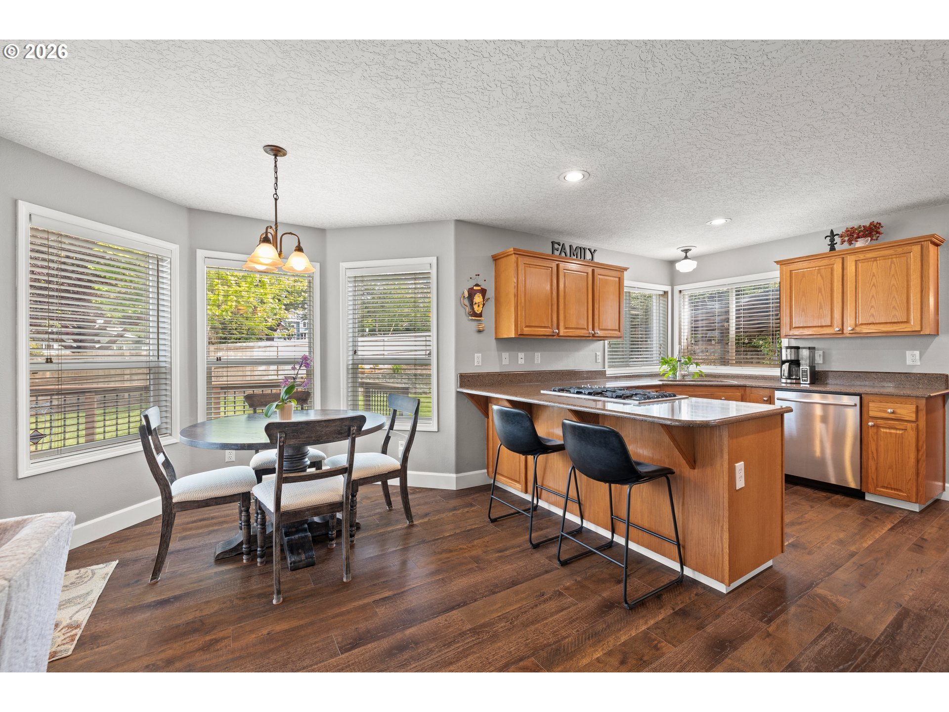 4549 Southeast 10th Terrace Gresham, OR 97080 - Photo 12 of 44 a living room with stainless steel appliances kitchen island granite countertop furniture and a wooden floor