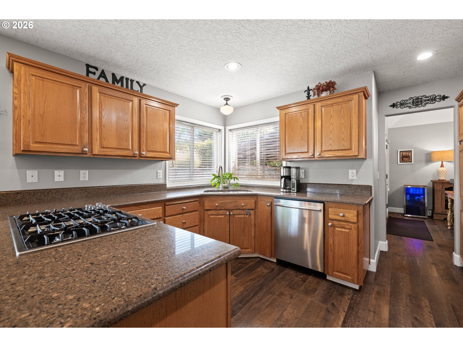 4549 Southeast 10th Terrace Gresham, OR 97080 - Photo 16 of 44 a kitchen with stainless steel appliances granite countertop a stove a sink dishwasher and cabinets with wooden floor
