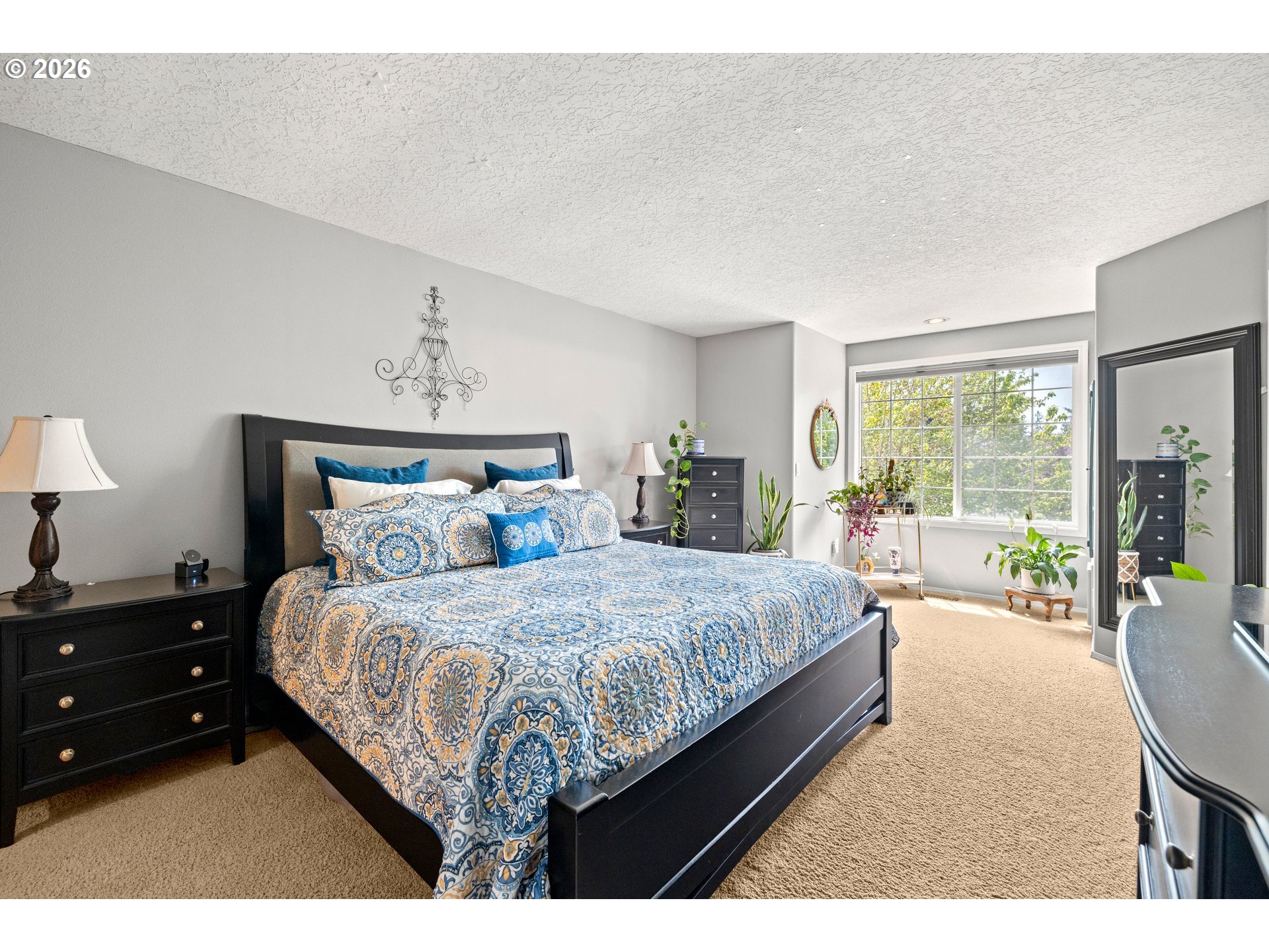 4549 Southeast 10th Terrace Gresham, OR 97080 - Photo 19 of 44 a bed sitting in a bedroom next to a large window