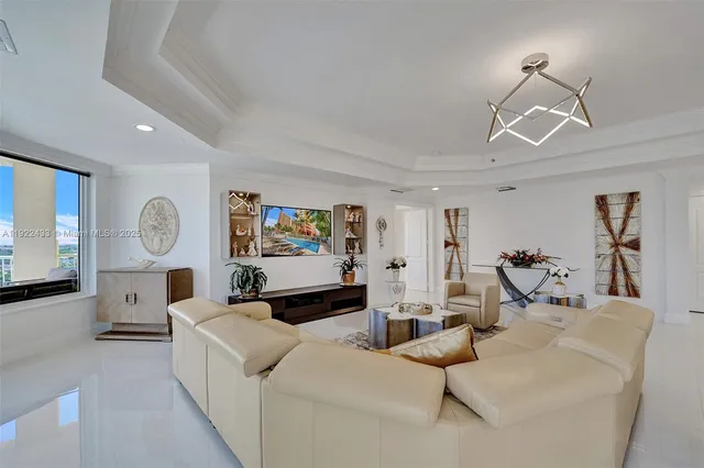 a living room with furniture and a chandelier