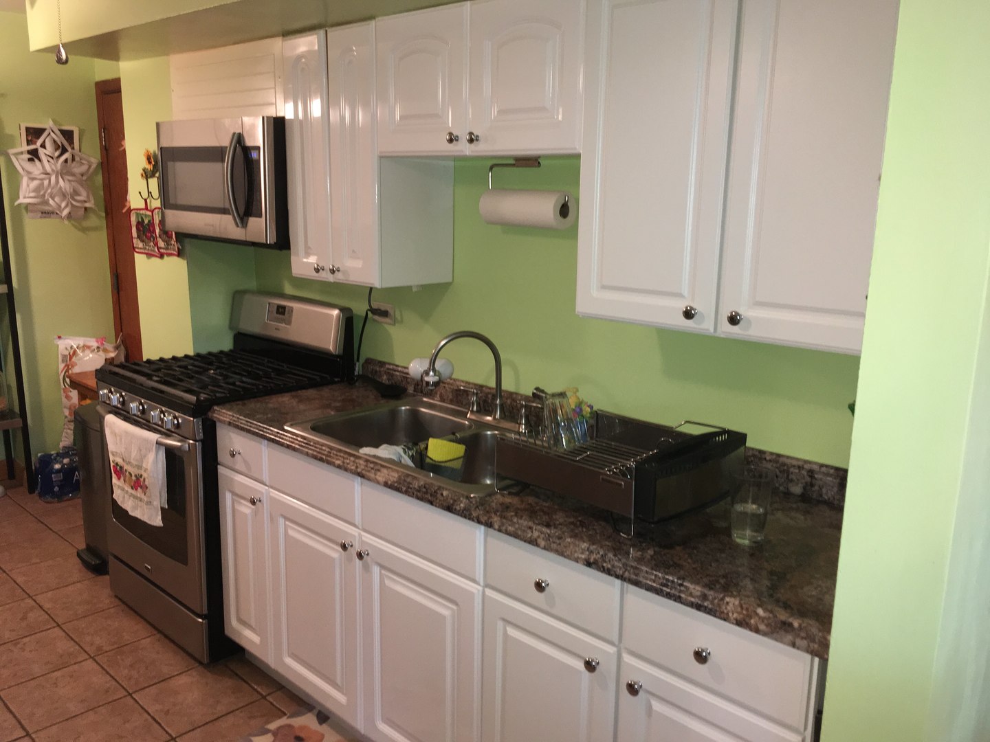 708 Dempster Street, Unit F202 Mount Prospect, IL 60056 - Photo 3 of 14 a kitchen with granite countertop a sink a stove and cabinets