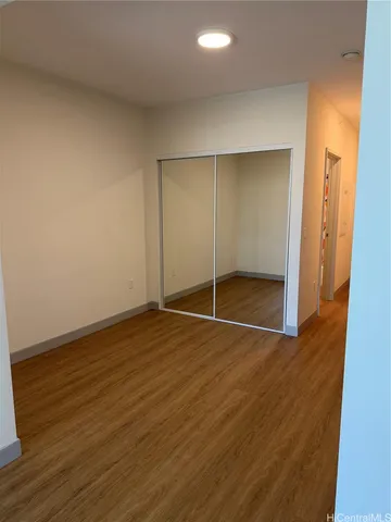 an empty room with wooden floor and door