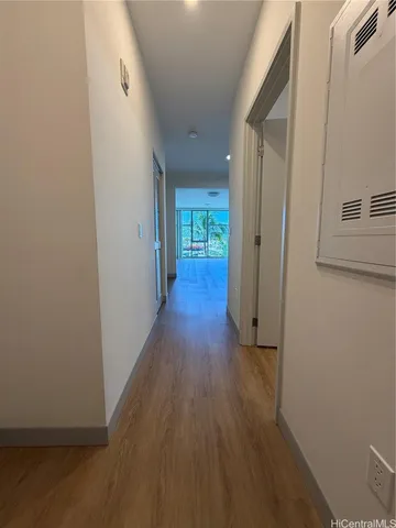a view of a hallway with wooden floor